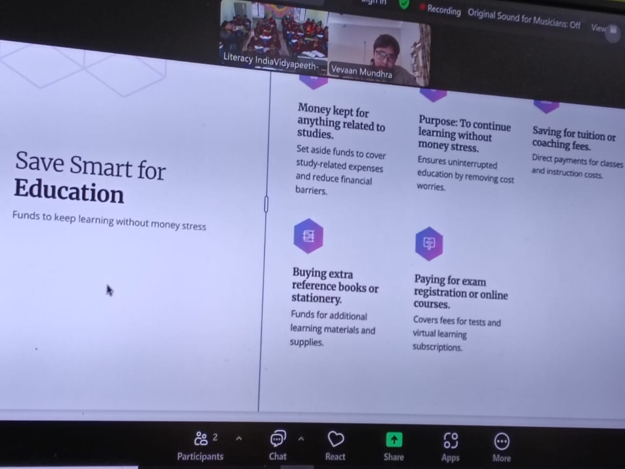 A curriculum slide on the classroom screen — Save Smart for Education — covering tuition, reference books, exam fees and uninterrupted learning
