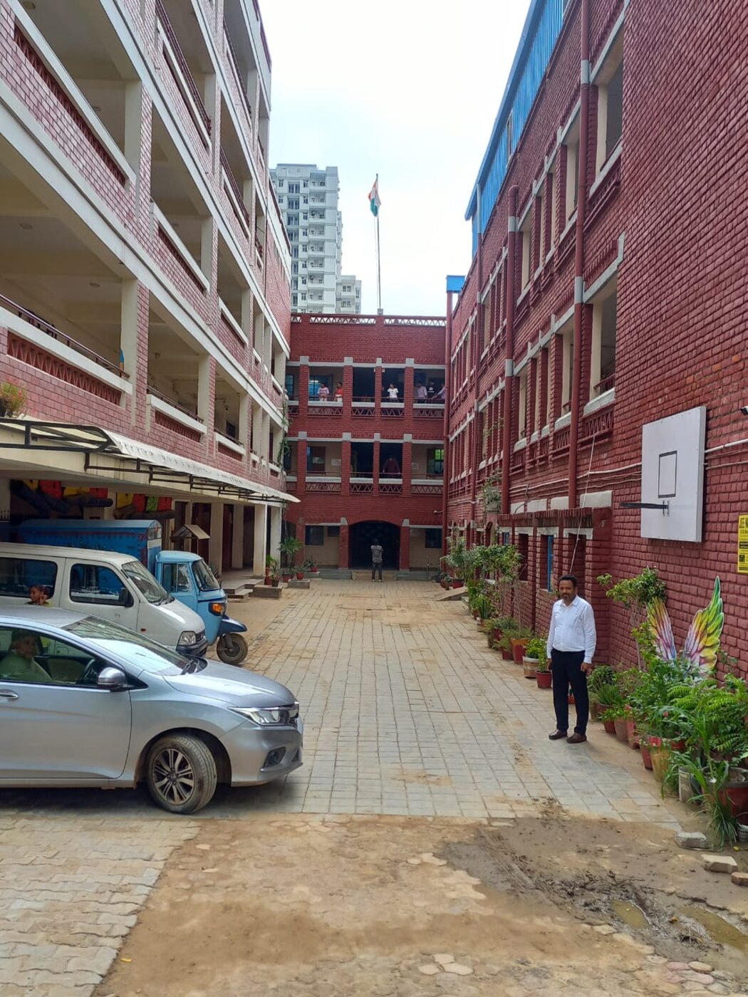Literacy India Vidyapeeth in Gurugram — view of the red-brick school campus with the central courtyard and Indian flag